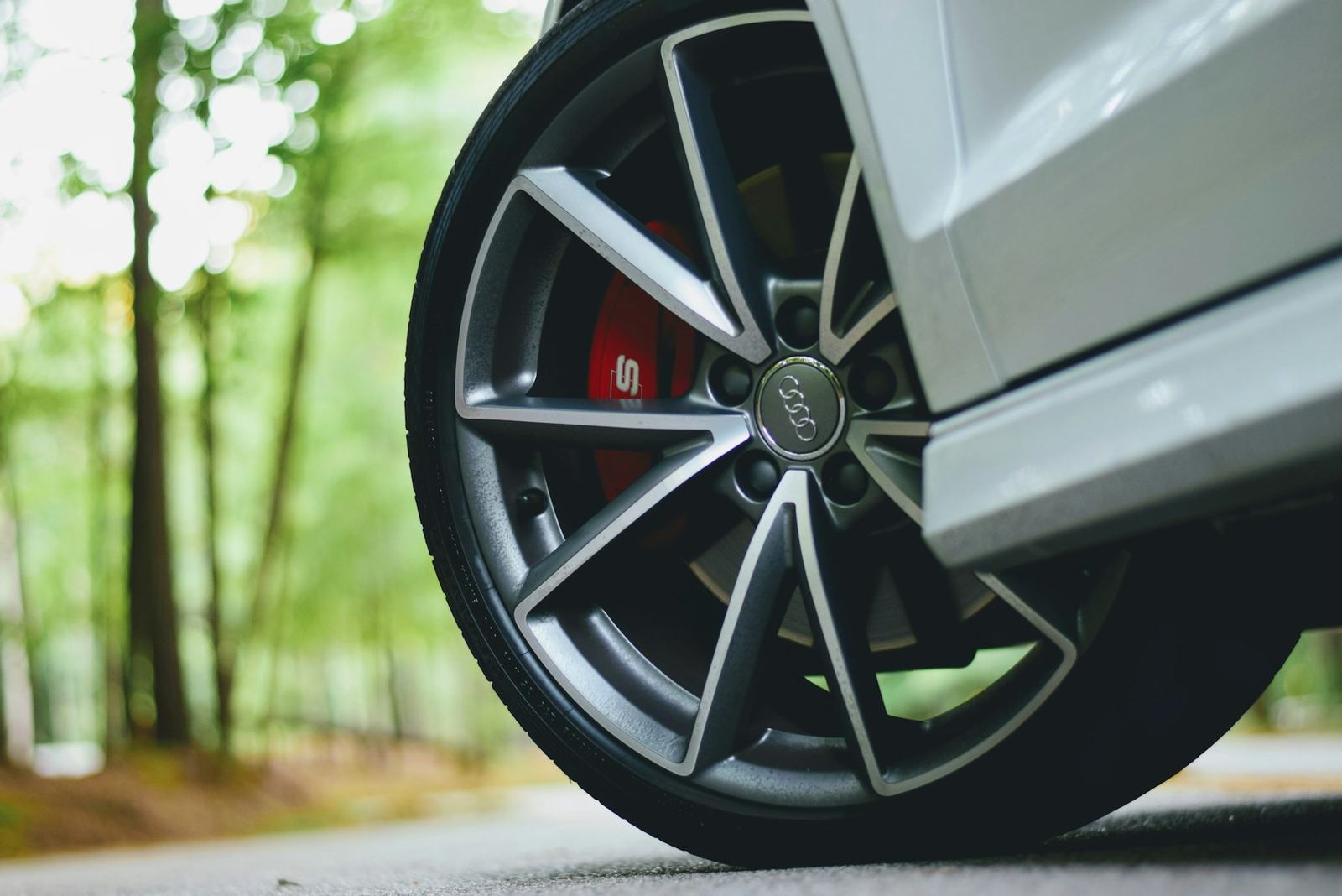 A close up of an alloy wheel and brake caliper